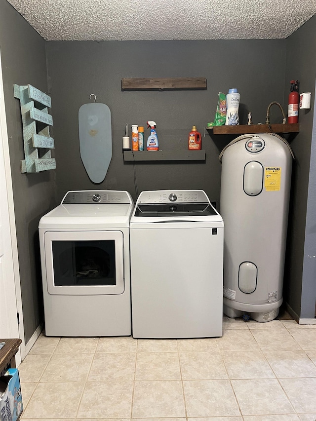 911 Apple Rd, Bonnerdale, AR 71933 - laundry room with washer and dryer, electric water heater, a textured ceiling, and light tile patterned floors