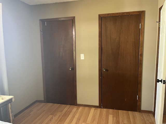 911 Apple Rd, Bonnerdale, AR 71933 - unfurnished bedroom featuring light wood-type flooring and baseboards
