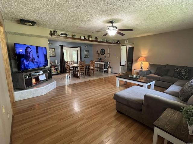 911 Apple Rd, Bonnerdale, AR 71933 - living room featuring wood finished floors, ceiling fan, and a textured ceiling