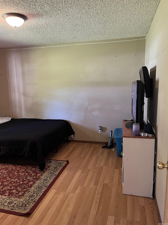 911 Apple Rd, Bonnerdale, AR 71933 - bedroom with a textured ceiling and light wood-type flooring