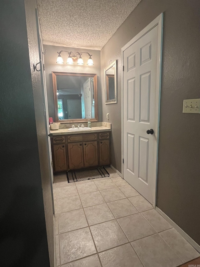 911 Apple Rd, Bonnerdale, AR 71933 - bathroom with tile patterned floors, a textured ceiling, vanity, and a textured wall
