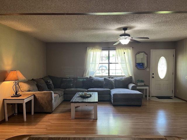 911 Apple Rd, Bonnerdale, AR 71933 - living room featuring wood finished floors, ceiling fan, and a textured ceiling