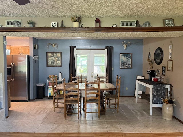 911 Apple Rd, Bonnerdale, AR 71933 - dining area with light tile patterned floors, a textured ceiling, and baseboards