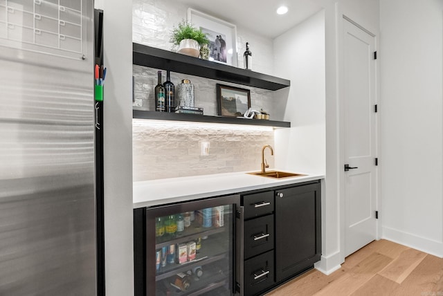 6700 Hawthorne Rd, Little Rock, AR 72207 - indoor wet bar with wine cooler, light wood finished floors, backsplash, stainless steel refrigerator, and recessed lighting