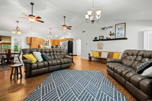 67 Delton Mccauley Rd, Kirby, AR 71950 - living room featuring a ceiling fan, vaulted ceiling, dark wood-style floors, a chandelier, and arched walkways