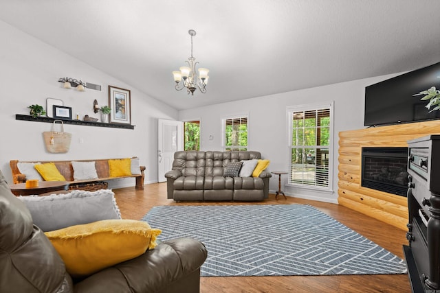 67 Delton Mccauley Rd, Kirby, AR 71950 - living area featuring a chandelier, lofted ceiling, wood finished floors, and baseboards