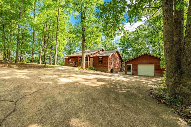 67 Delton Mccauley Rd, Kirby, AR 71950 - view of front of house with an outbuilding, driveway, a detached garage, and covered porch