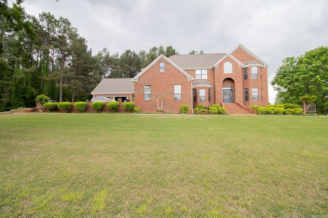 view of front of house with brick siding and a front lawn