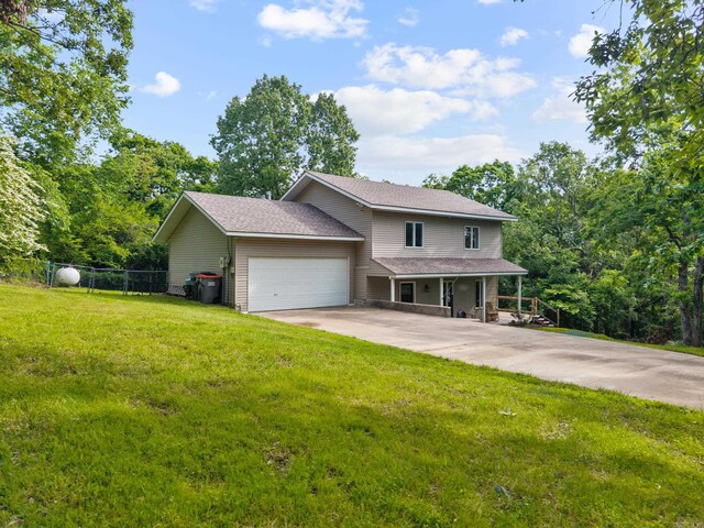 15364 Twin Pines Rd, Lowell, AR 72745 - view of front facade with an attached garage, a porch, and concrete driveway