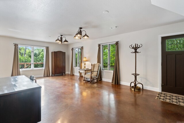15364 Twin Pines Rd, Lowell, AR 72745 - foyer featuring finished concrete floors, baseboards, and a chandelier