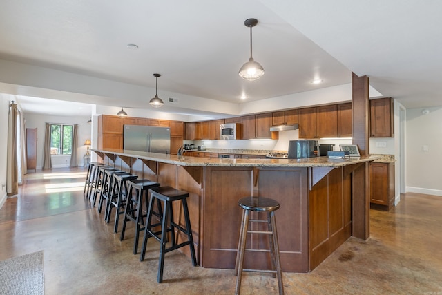 15364 Twin Pines Rd, Lowell, AR 72745 - kitchen with appliances with stainless steel finishes, finished concrete flooring, brown cabinets, baseboards, and hanging light fixtures