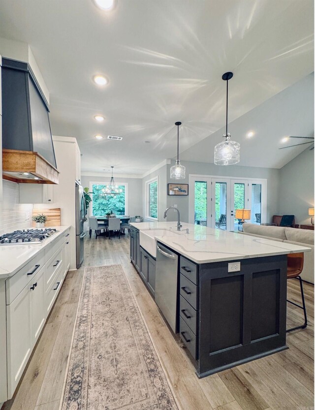 816 Nature Way, Benton, AR 72019 - kitchen featuring stainless steel appliances, a sink, light wood-style flooring, light stone countertops, and premium range hood