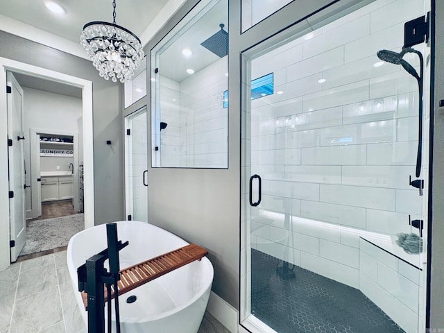 816 Nature Way, Benton, AR 72019 - bathroom featuring a freestanding bath, a shower stall, a chandelier, baseboards, and recessed lighting