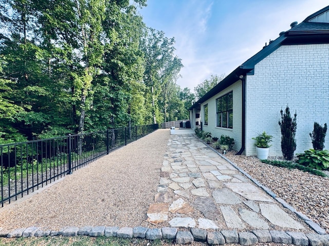 816 Nature Way, Benton, AR 72019 - view of side of home featuring a fenced backyard, brick siding, and a patio area
