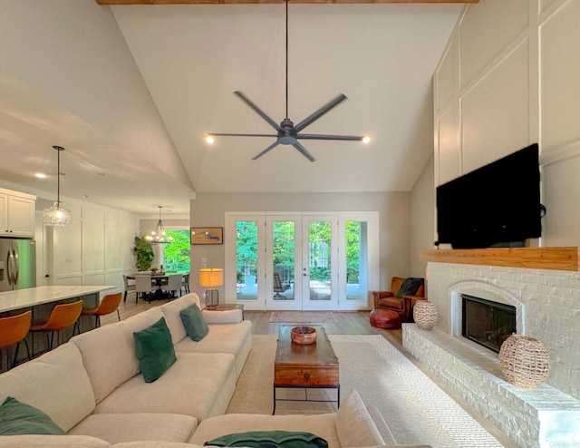 816 Nature Way, Benton, AR 72019 - living area featuring vaulted ceiling, a ceiling fan, wood finished floors, a brick fireplace, and recessed lighting