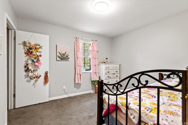 carpeted bedroom featuring baseboards