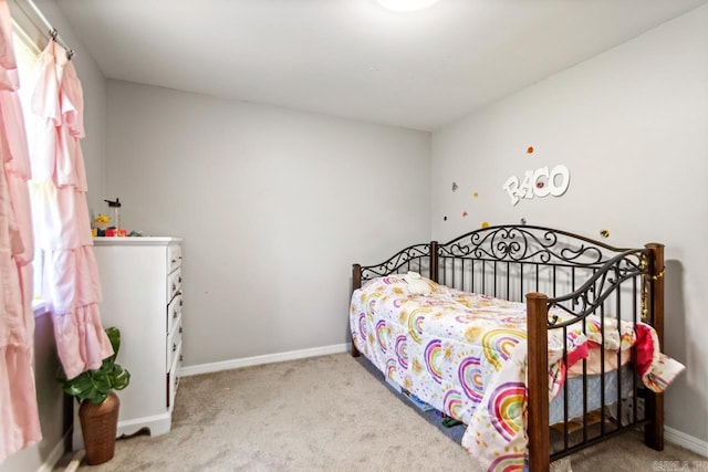 bedroom with carpet and baseboards