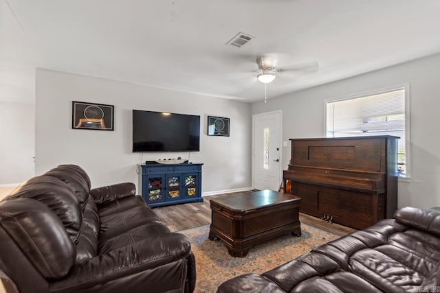 living room with ceiling fan, wood finished floors, and baseboards