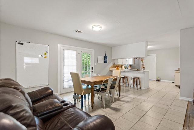 dining space with light tile patterned flooring and baseboards