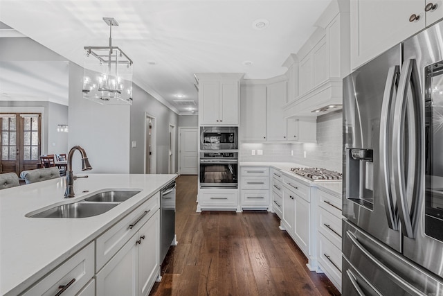 20 Caurel Ct, Little Rock, AR 72223 - kitchen featuring appliances with stainless steel finishes, a sink, light countertops, ornamental molding, and dark wood finished floors