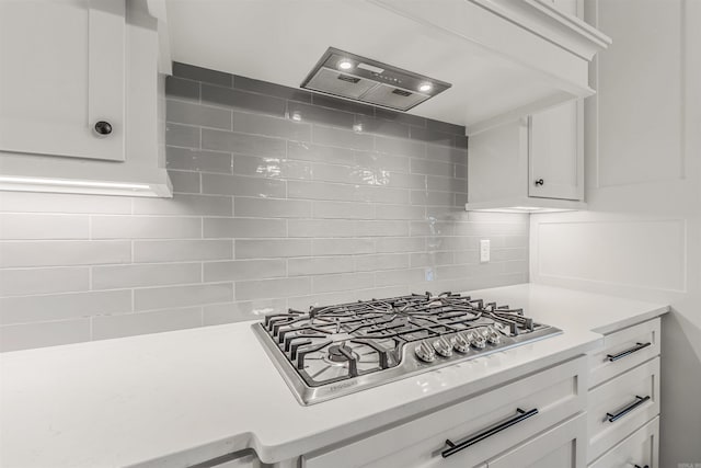 20 Caurel Ct, Little Rock, AR 72223 - kitchen featuring light countertops, white cabinets, backsplash, and wall chimney range hood