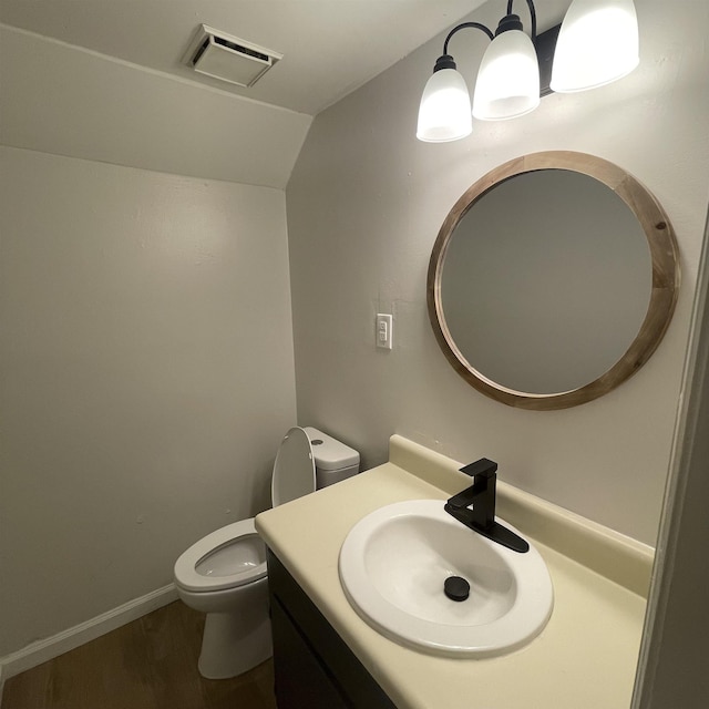 1302-1304 Santa Fe, Jonesboro, AR 72401 - bathroom with vaulted ceiling, toilet, wood finished floors, vanity, and baseboards