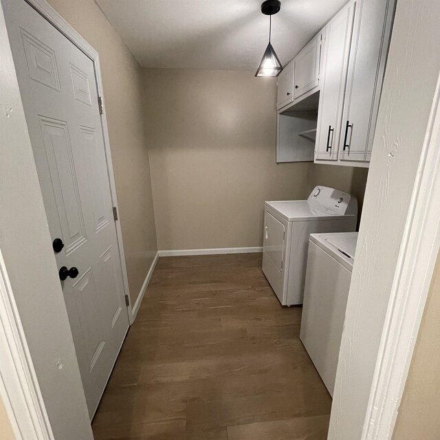 1302-1304 Santa Fe, Jonesboro, AR 72401 - clothes washing area featuring independent washer and dryer, cabinet space, wood finished floors, and baseboards