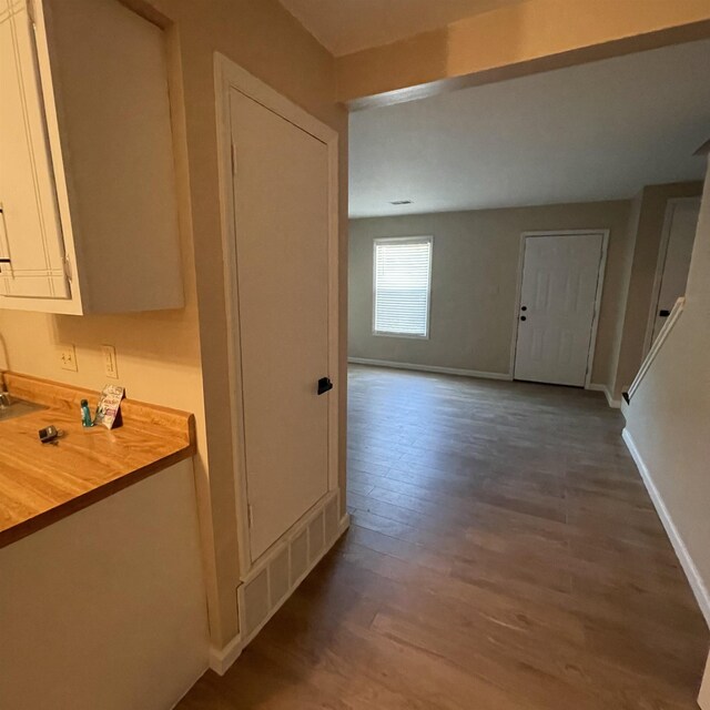 1302-1304 Santa Fe, Jonesboro, AR 72401 - hallway featuring dark wood-style flooring and baseboards
