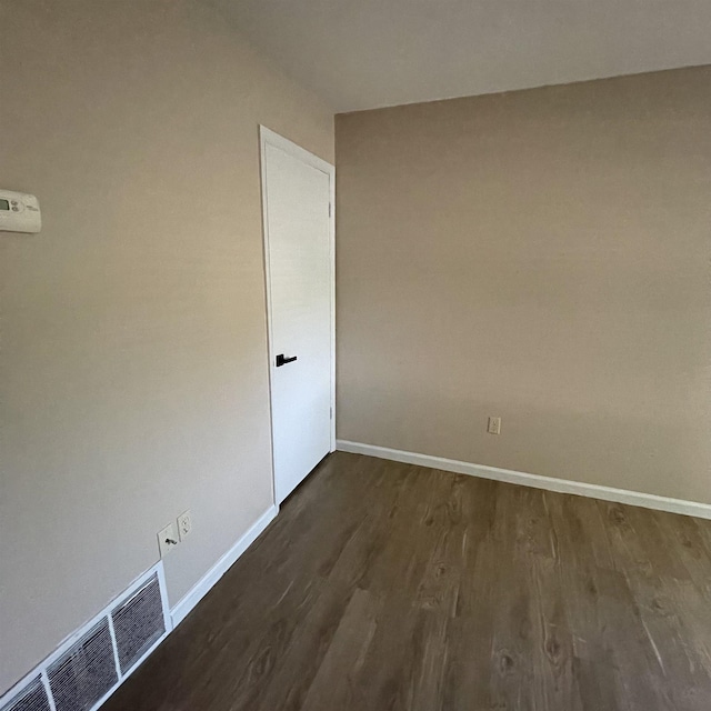 1302-1304 Santa Fe, Jonesboro, AR 72401 - spare room with dark wood finished floors and baseboards
