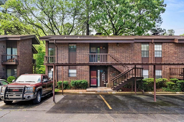 2325 Lakeshore Unit E-4, Hot Springs, AR 71913 - view of front of home with covered and uncovered parking, brick siding, and stairway