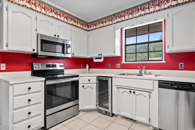 2325 Lakeshore Unit E-4, Hot Springs, AR 71913 - kitchen featuring stainless steel appliances, a sink, beverage cooler, light countertops, and ornamental molding
