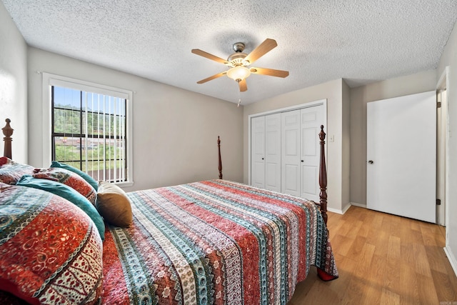 2325 Lakeshore Unit E-4, Hot Springs, AR 71913 - bedroom featuring light wood-style flooring, a ceiling fan, a textured ceiling, baseboards, and a closet