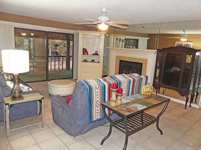 2325 Lakeshore Unit E-4, Hot Springs, AR 71913 - tiled living room with a ceiling fan, a textured ceiling, and a fireplace