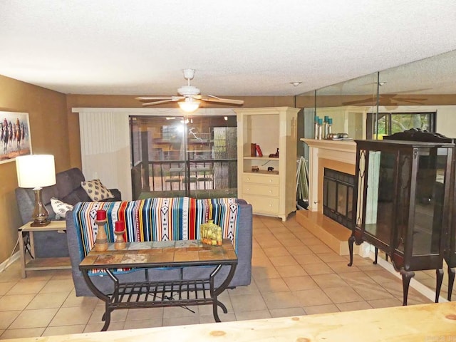 2325 Lakeshore Unit E-4, Hot Springs, AR 71913 - living area with tile patterned flooring, ceiling fan, a glass covered fireplace, and a textured ceiling