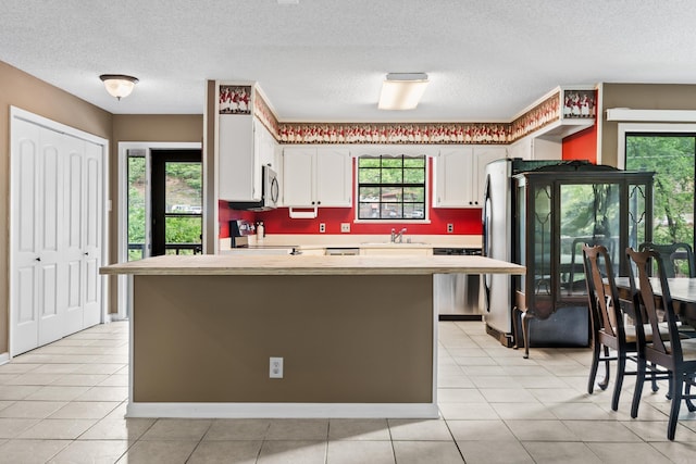 2325 Lakeshore Unit E-4, Hot Springs, AR 71913 - kitchen with a sink, stove, stainless steel microwave, light countertops, and white cabinets