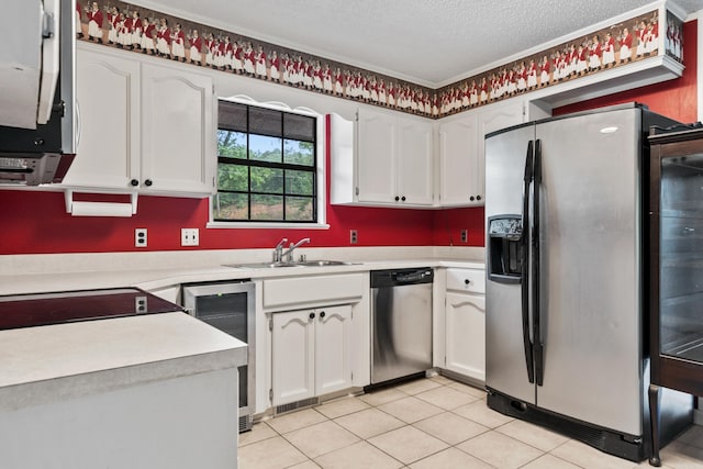 2325 Lakeshore Unit E-4, Hot Springs, AR 71913 - kitchen with appliances with stainless steel finishes, a textured ceiling, light countertops, a sink, and white cabinetry