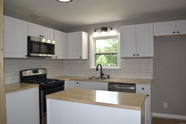 27 Grant 491 Rd, Sheridan, AR 72105 - kitchen with stainless steel appliances, butcher block counters, a sink, and backsplash