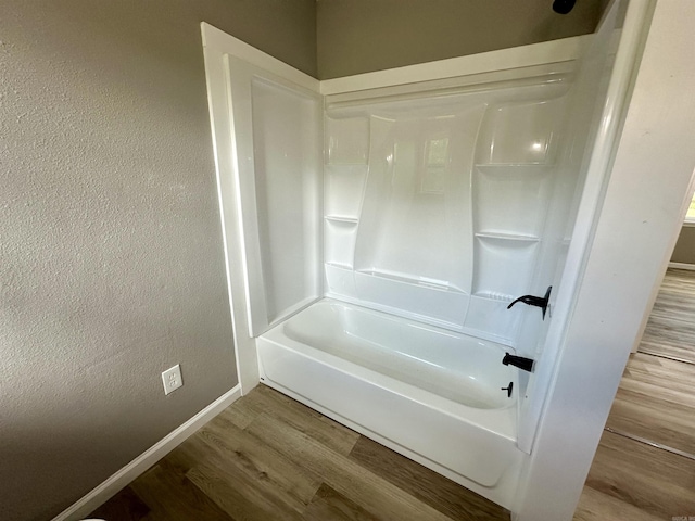 27 Grant 491 Rd, Sheridan, AR 72105 - full bathroom featuring wood finished floors,  shower combination, and baseboards