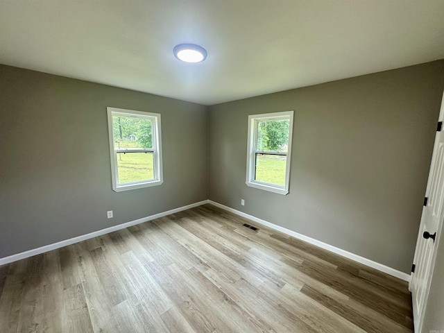 27 Grant 491 Rd, Sheridan, AR 72105 - spare room featuring plenty of natural light, wood finished floors, and baseboards