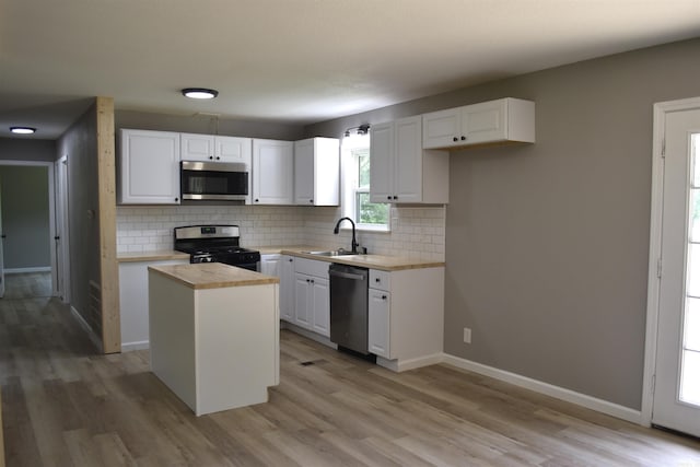 27 Grant 491 Rd, Sheridan, AR 72105 - kitchen with appliances with stainless steel finishes, a sink, white cabinets, and light wood finished floors