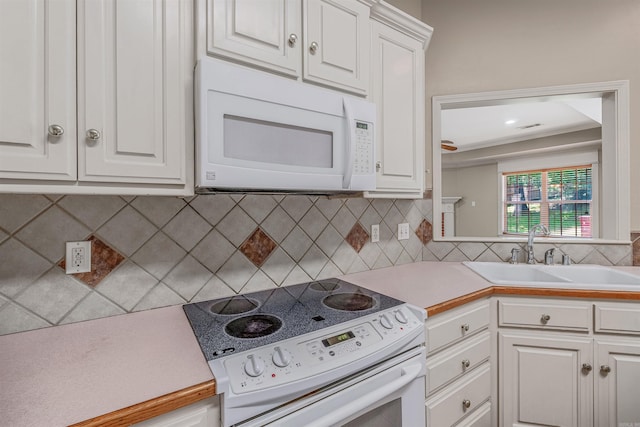1010 Claycut Cir, North Little Rock, AR 72116 - kitchen featuring white appliances, a sink, and white cabinets