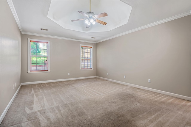 1010 Claycut Cir, North Little Rock, AR 72116 - empty room featuring light carpet, a tray ceiling, a ceiling fan, ornamental molding, and baseboards