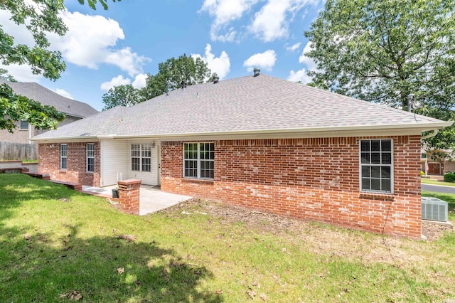 1010 Claycut Cir, North Little Rock, AR 72116 - rear view of house featuring central AC unit, a shingled roof, brick siding, a yard, and a patio