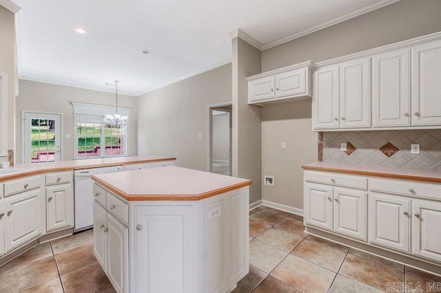 1010 Claycut Cir, North Little Rock, AR 72116 - kitchen featuring white dishwasher, a center island, a chandelier, light countertops, and tasteful backsplash
