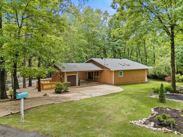 9 Valls Cir, Hot Springs Village, AR 71909 - back of property with driveway, a lawn, an attached garage, and roof with shingles