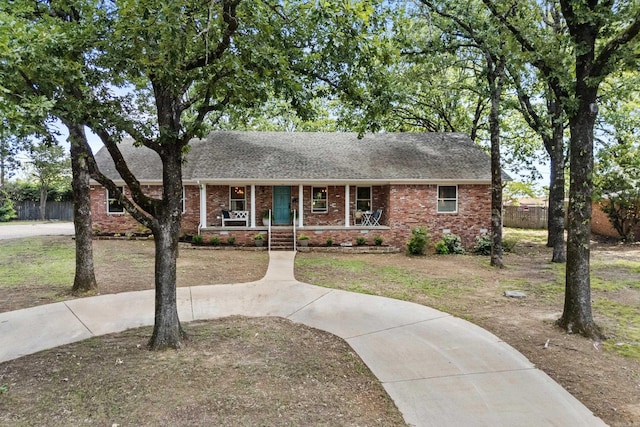 42 Desoto Cir, North Little Rock, AR 72116 - view of front of property featuring covered porch, fence, brick siding, and a shingled roof
