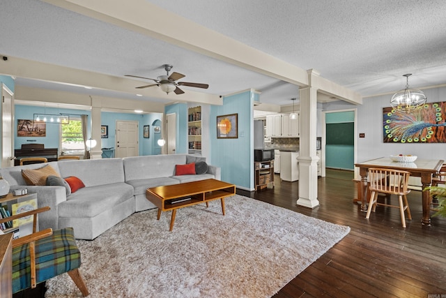 42 Desoto Cir, North Little Rock, AR 72116 - living room featuring decorative columns, a textured ceiling, dark wood-style flooring, a ceiling fan, and a chandelier