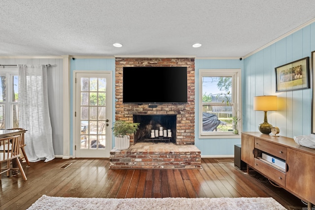 42 Desoto Cir, North Little Rock, AR 72116 - living area with ornamental molding, a textured ceiling, hardwood / wood-style floors, a brick fireplace, and baseboards