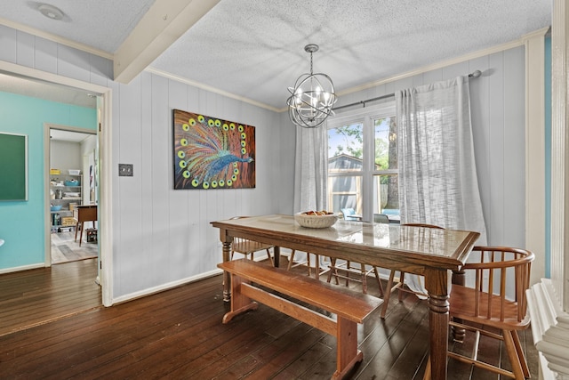 42 Desoto Cir, North Little Rock, AR 72116 - dining room with ornamental molding, dark wood finished floors, a chandelier, a textured ceiling, and baseboards