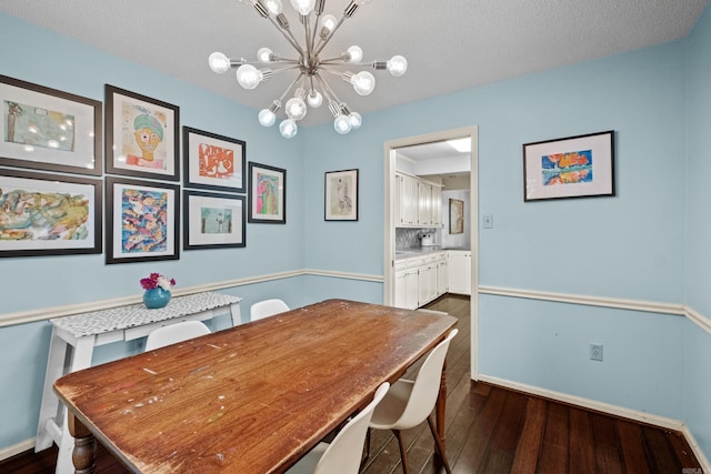 42 Desoto Cir, North Little Rock, AR 72116 - dining room featuring dark wood-style floors, a chandelier, and baseboards